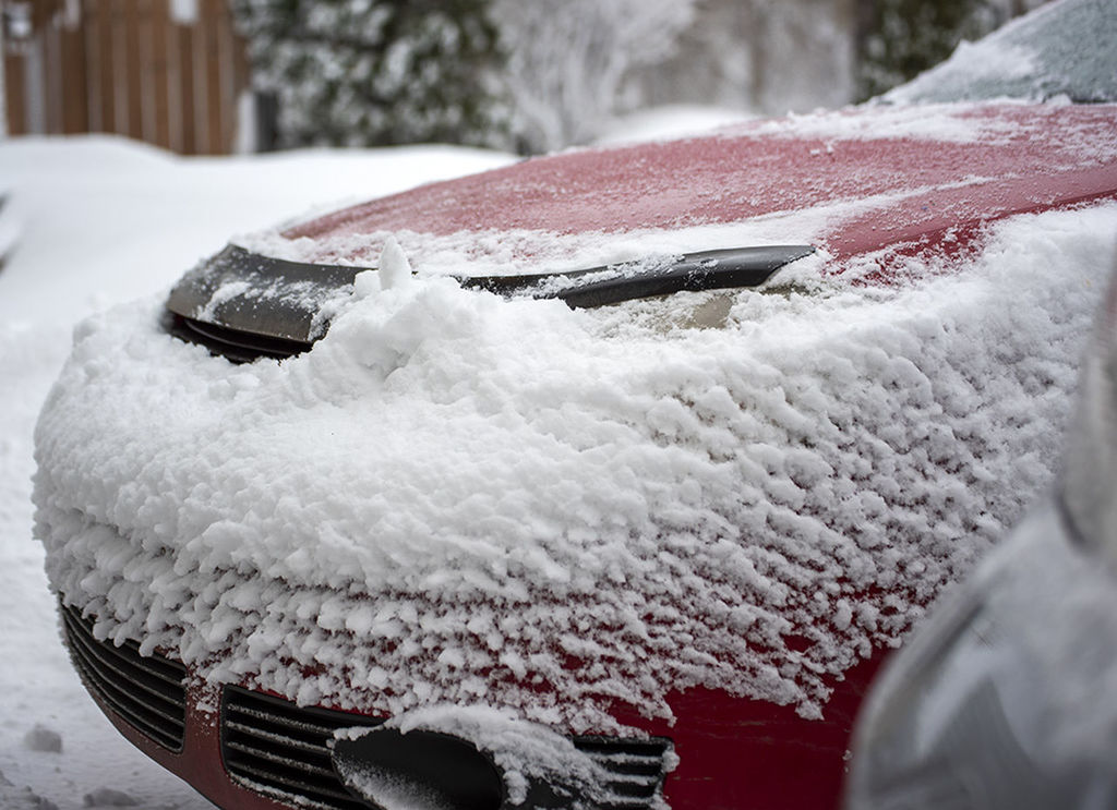 CLOSE-UP OF SNOW COVERED CAR