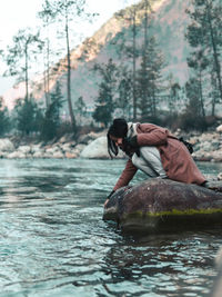 Man and woman on river in forest