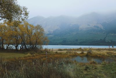 Scenic view of lake and mountains against sky