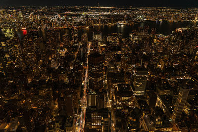 Aerial view of illuminated buildings in city at night