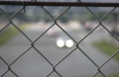 Full frame shot of chainlink fence against sky