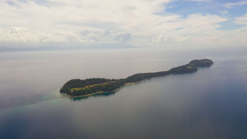 Tropical big liguid island in the blue sea with a coral reef and the beach. big cruz island