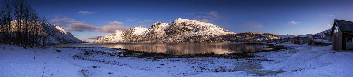 Panoramic view of snowcapped mountains against sky during winter