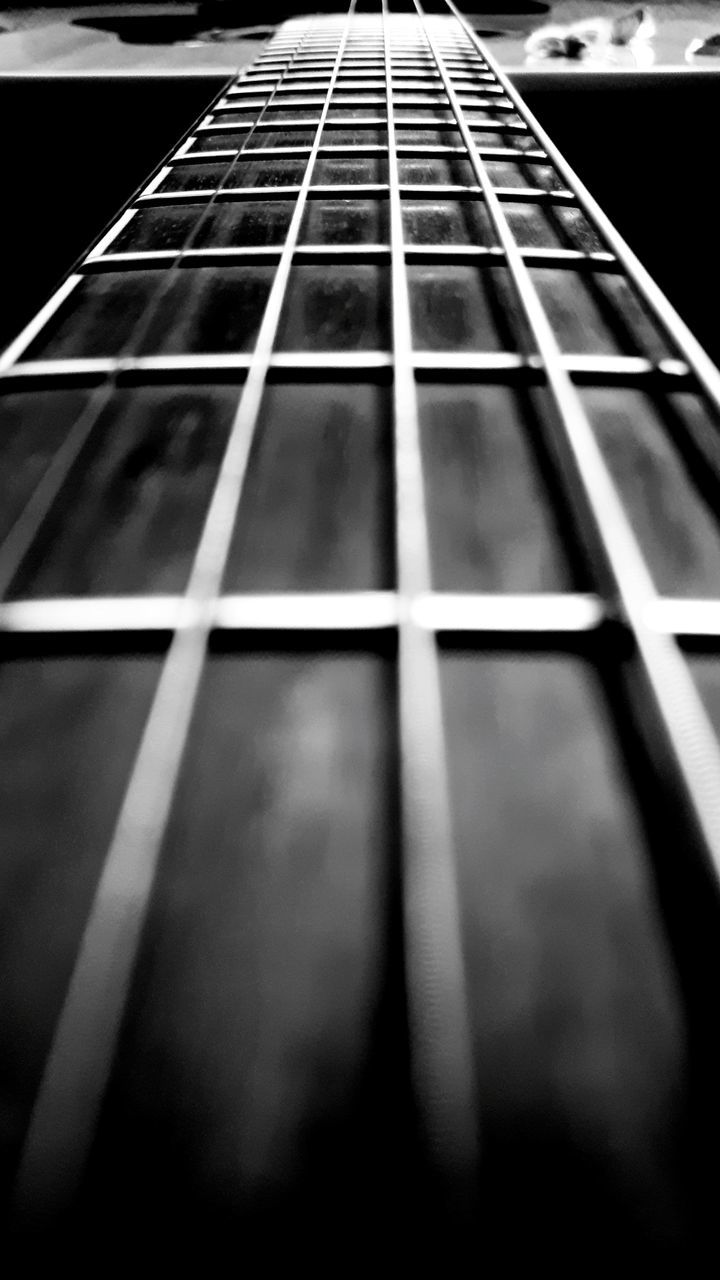 black and white, musical instrument, monochrome, string instrument, guitar, musical instrument string, monochrome photography, black, music, musical equipment, white, arts culture and entertainment, string, plucked string instruments, acoustic guitar, close-up, no people, indoors, bass guitar, line, selective focus, fretboard, darkness