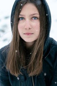 Portrait of young girl outside while snowing