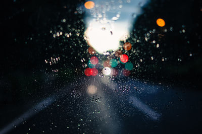 Close-up of wet car window at night