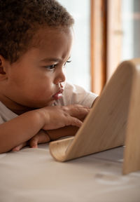 Portrait of boy looking at camera at home