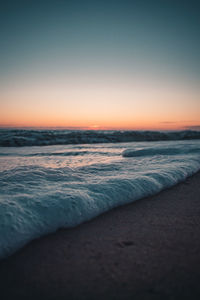 Scenic view of sea against clear sky during sunset