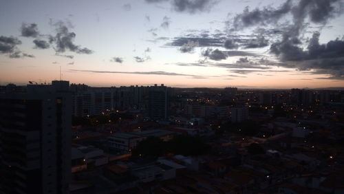 High angle view of illuminated buildings against sky at sunset