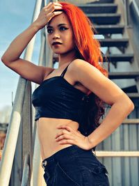 Portrait of beautiful young woman standing at home