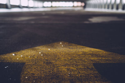 Close-up of arrow symbol in parking lot