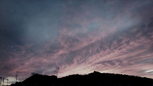 Low angle view of cloudy sky at sunset