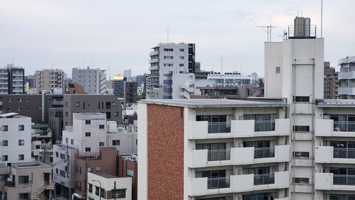 Buildings in city against sky