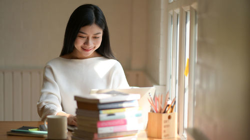 Young woman reading book