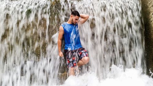 Man surfing on waterfall