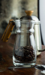 Close-up of coffee beans in glass jar on table