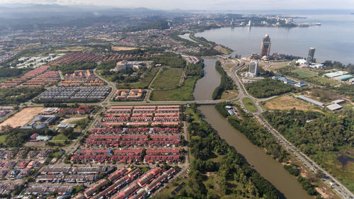 High angle view of townscape by river in city