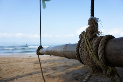 Close-up of rope tied on wood