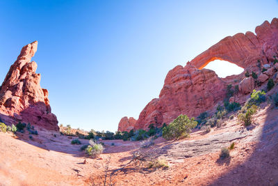 Rock formations on mountain against blue sky