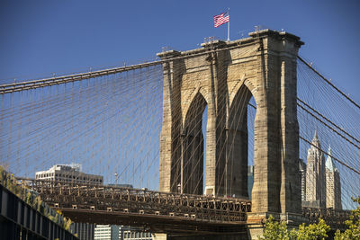 Low angle view of suspension bridge against sky