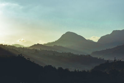 Scenic view of silhouette mountains against sky during sunset