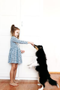 Full length of woman with cat on floor