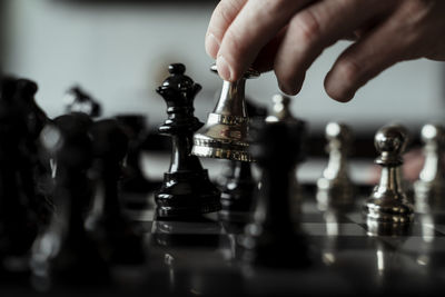 Midsection of man playing with chess