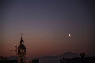 Low angle view of silhouette buildings against sky at sunset