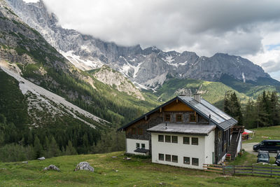 Houses on snowcapped mountains against sky