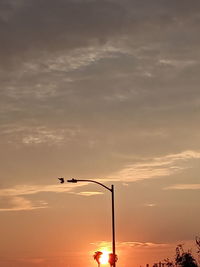 Low angle view of silhouette street light against sky during sunset