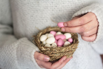 Midsection of woman with almond candies