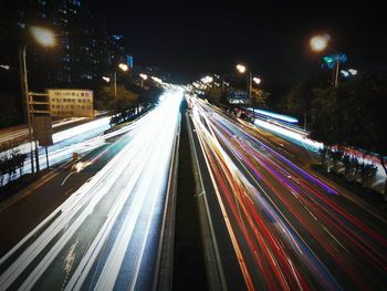 High angle view of light trails on road at night