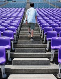 Rear view of woman walking on staircase