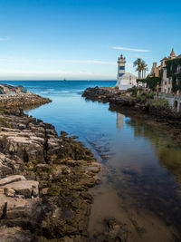 Scenic view of sea and buildings against sky