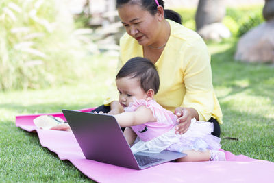 Mother and daughter using smart phone