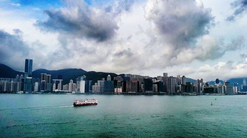 View of boats in sea against cloudy sky