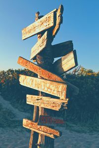 Low angle view of road sign against clear sky