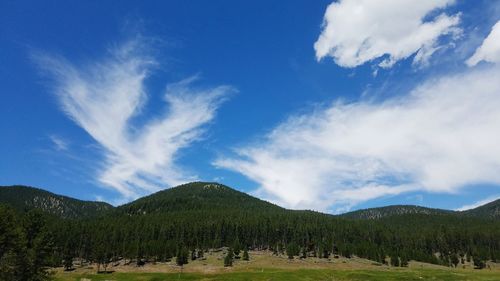 Scenic view of mountains against blue sky