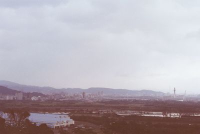 Scenic view of river and mountains against sky