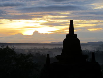 Silhouette temple against sky during sunset