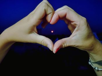 Close-up of hands holding heart shape