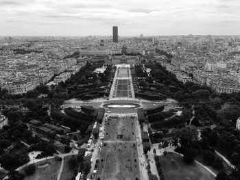 Champ de mars seen through eiffel tower in city