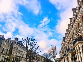 Low angle view of buildings against cloudy sky