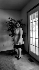 Young woman standing in corridor