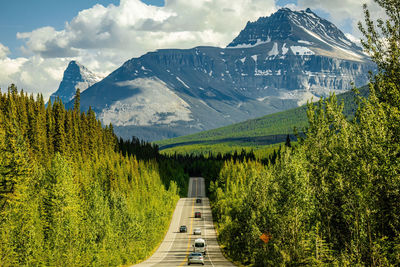 Scenic view of road with mountains against sky - icefield parkway, canada