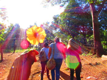 People on road amidst trees