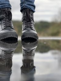 Low section of person with reflection of water