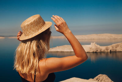 Woman wearing hat against sky