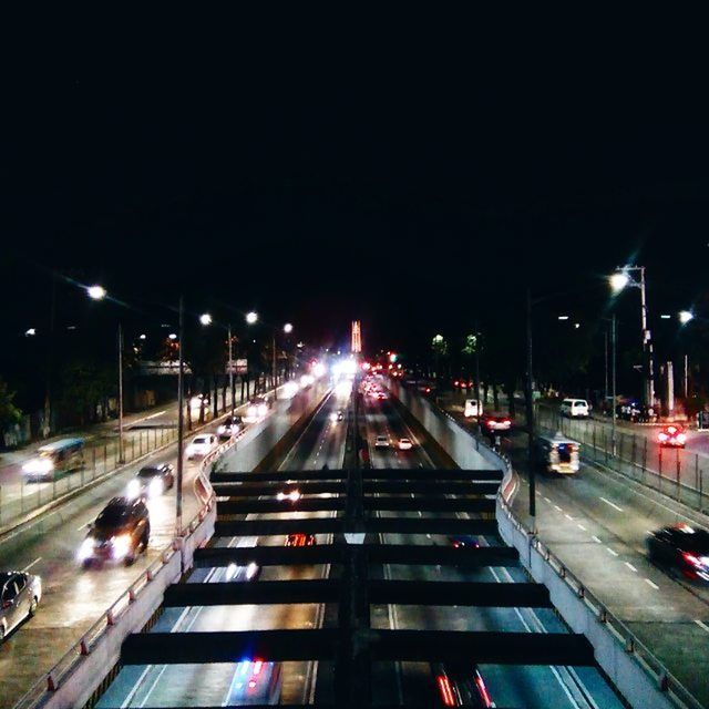 illuminated, night, transportation, street light, light trail, long exposure, city, mode of transport, car, motion, traffic, road, speed, land vehicle, street, built structure, architecture, building exterior, high angle view, the way forward