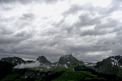 Scenic view of mountains against cloudy sky